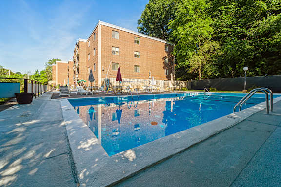 a swimming pool with a building in the background