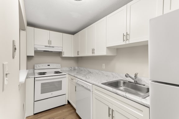 the preserve at ballantyne commons apartment kitchen with white cabinets and appliances at Flats at Merrill Pond, Worcester, MA
