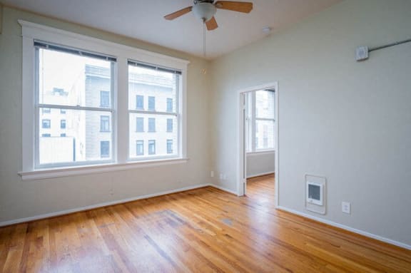 an empty living room with a ceiling fan and wood floors at Whitney Gray, Portland, 97205 ?