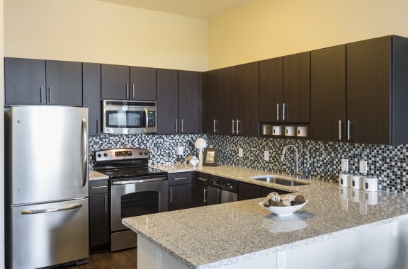 a kitchen with stainless steel appliances and granite counter tops