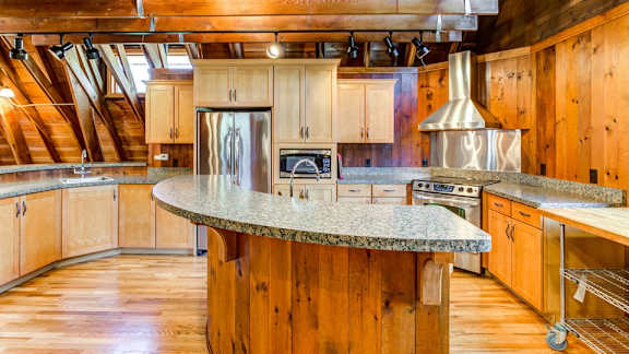 A kitchen with wooden cabinets and a granite countertop.
