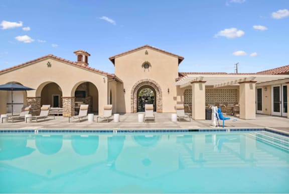 a swimming pool in front of a house with a pool