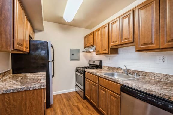 a kitchen with a stove top oven next to a refrigerator
