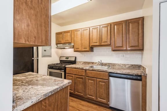 a kitchen with wooden cabinets and a stove top oven