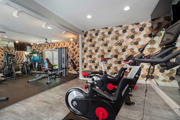 a gym with exercise equipment and a wall of tiles  at Ascent at Farmington Hills, Farmington Hills, 48331