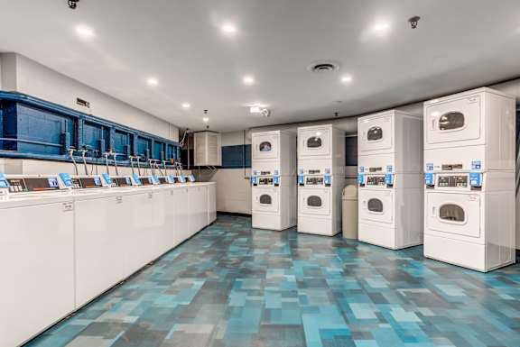 a laundry room with washers and dryers