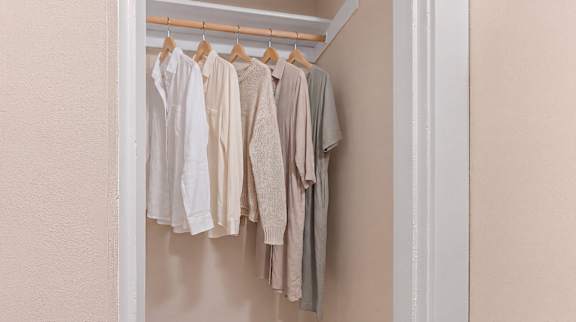 Clothes hanging on a clothes rack.