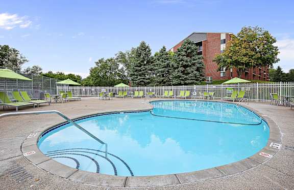 A round swimming pool with a blue water and a white line around it.
