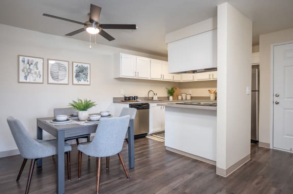 an open kitchen and dining room with a blue table and chairs at Sundial Apartments, Oregon