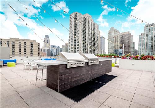 a rooftop bar with a view of the city