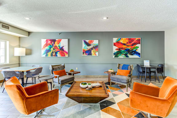 a living room with couches and chairs and a table