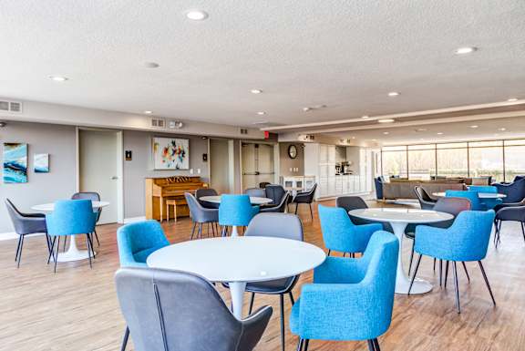 a common area with tables and chairs and a bar