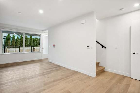 A room with wooden floors and white walls.