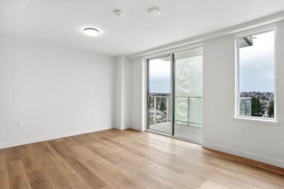 A room with a glass door leading outside.