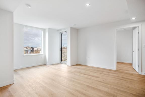 A room with wooden floors and white walls.