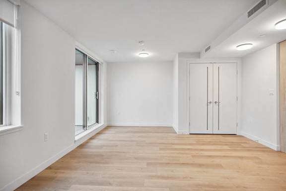 A room with wooden floors and white walls.