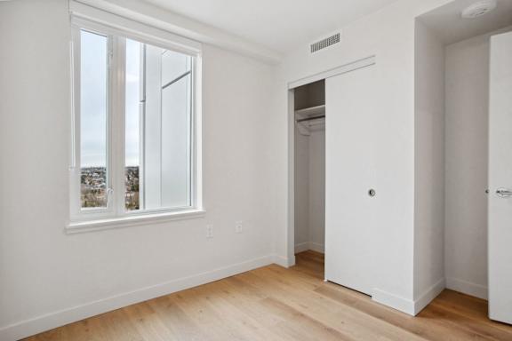 A white room with a window and a door.