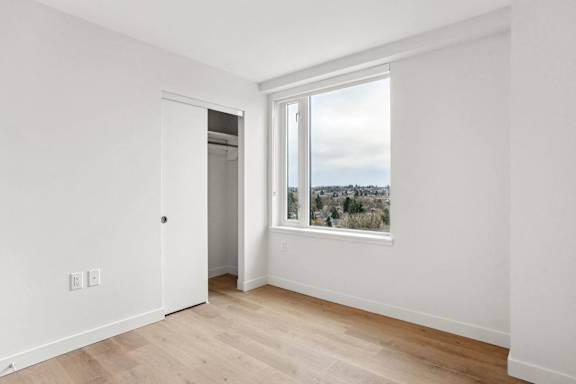 A room with a window and a door.