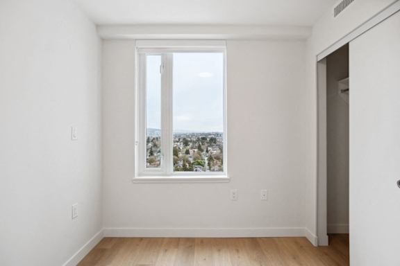 A room with a window overlooking a cityscape.