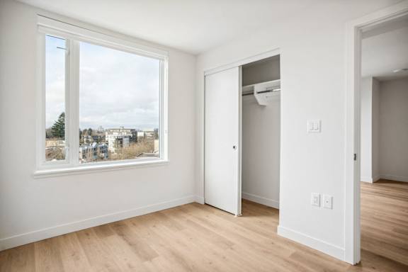 A room with a large window and a door.