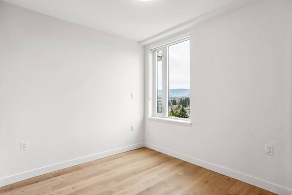 A room with a window overlooking a mountainous landscape.