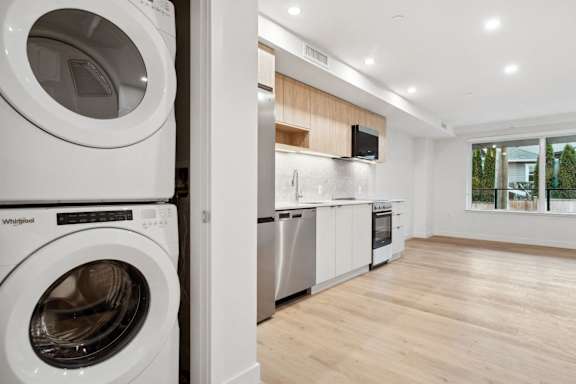 A modern laundry room with a washing machine and dryer.