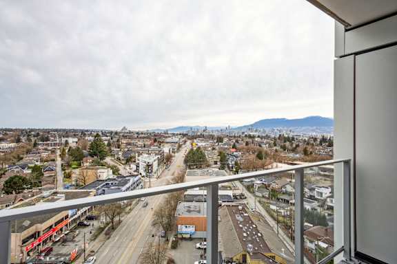 A view from a balcony overlooking a city street.