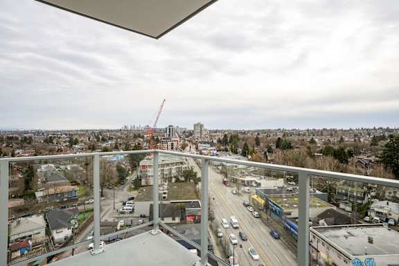 A view from a balcony overlooking a busy highway and a construction site.