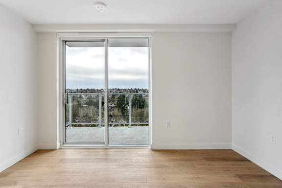 A room with a sliding glass door leading to a snowy landscape.