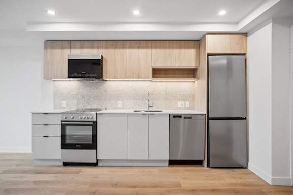 A modern kitchen with a wooden cabinet and stainless steel appliances.