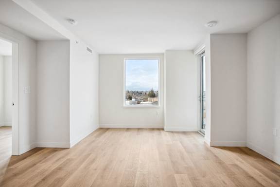 A room with wooden floors and white walls.