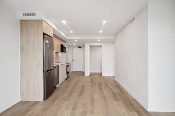 A kitchen with wooden floors and white walls.