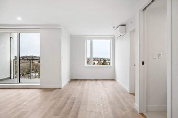A room with a sliding glass door and a window.