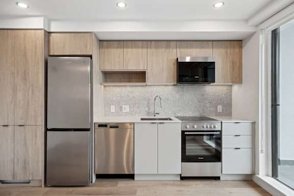 A modern kitchen with stainless steel appliances and wooden cabinets.