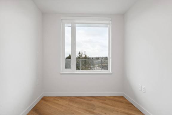 A room with a window overlooking a cityscape.
