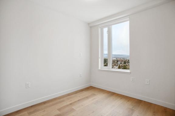 A room with a window overlooking a cityscape.
