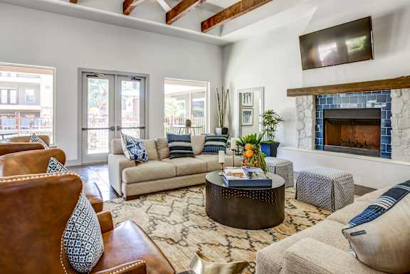 A living room with a fireplace and a television mounted on the wall.