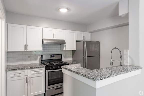 A kitchen with a stove, oven, and refrigerator.