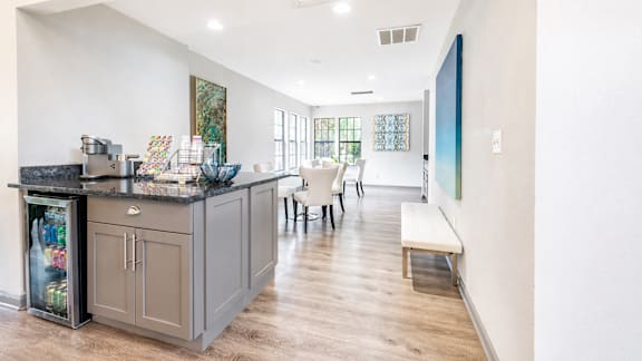 A kitchen with a bar and a bench.