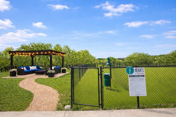 A sign in front of a fence that says "HEIGHTS".