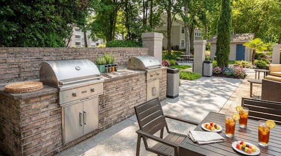 A backyard with a grill and a table with food and drinks.