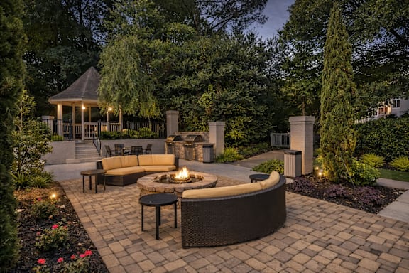 A backyard with a fire pit and seating area.