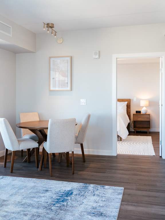 A dining room with a table and chairs.