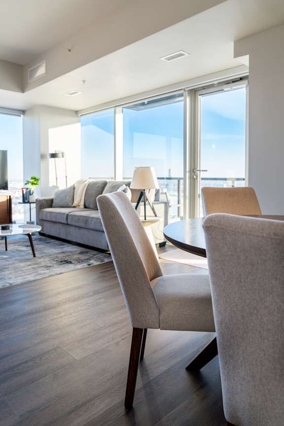 A modern living room with a large window and a view of the city.