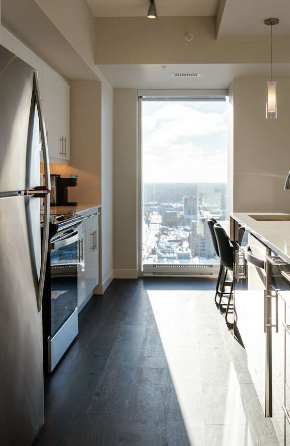A modern kitchen with a view of the city.