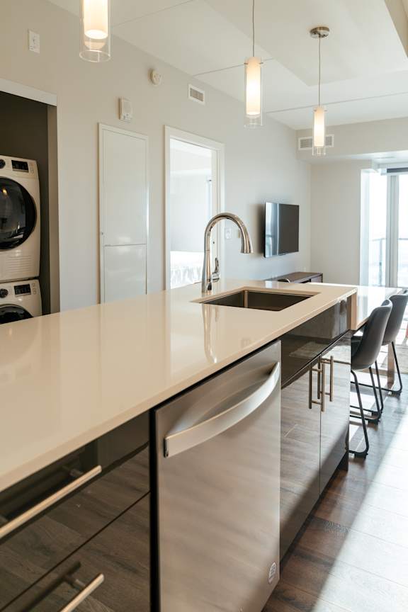 A modern kitchen with a large island and stainless steel appliances.