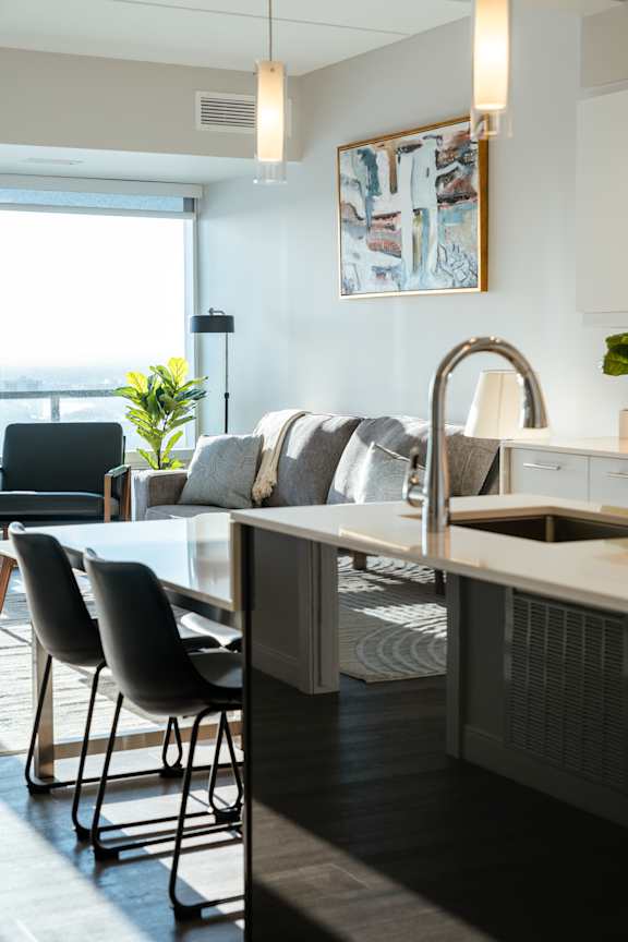 A modern kitchen with a dining table and chairs.