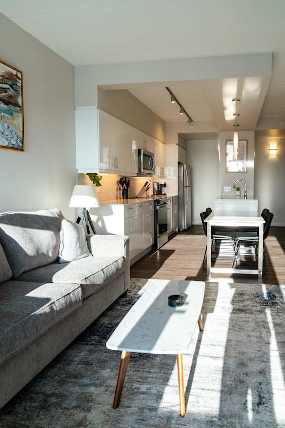 A modern living room with a grey sofa and a coffee table.