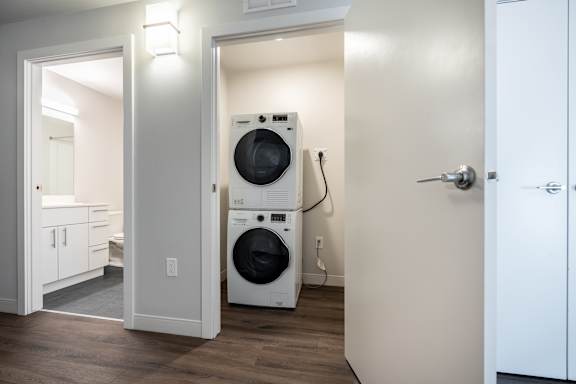 A white washer and dryer in a small laundry room.