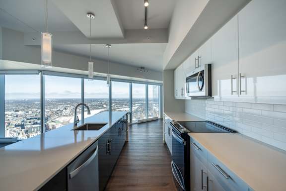 A modern kitchen with a view of the city.